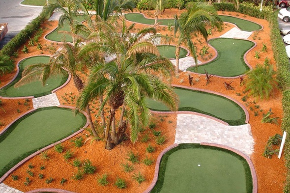 San Francisco Aerial view of a mini golf course with synthetic grass and palm trees.